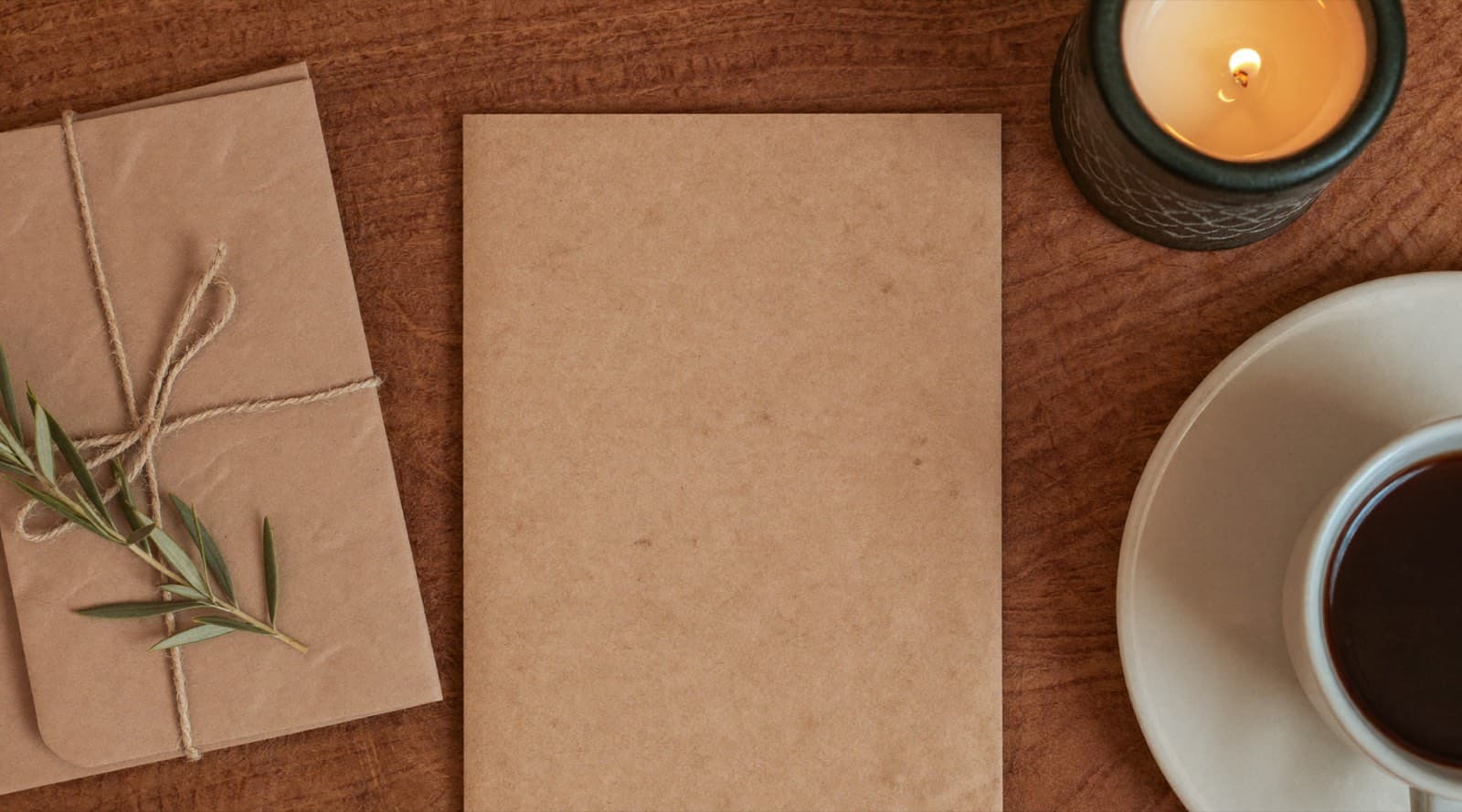 Kraft gift card in a linen envelope beside a candle